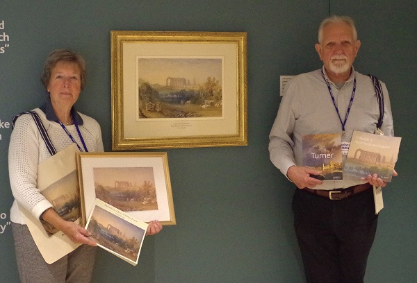 Volunteers Susan Mockler and Graham McDougal with the Turner prints