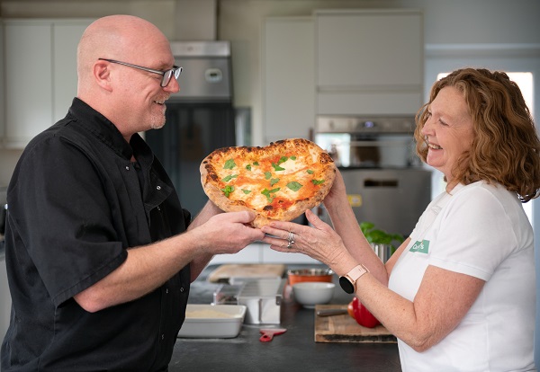 Elliott Richmond with his partner Rachael Willoughby, founders of CasaGees with their heart-shaped pizza!